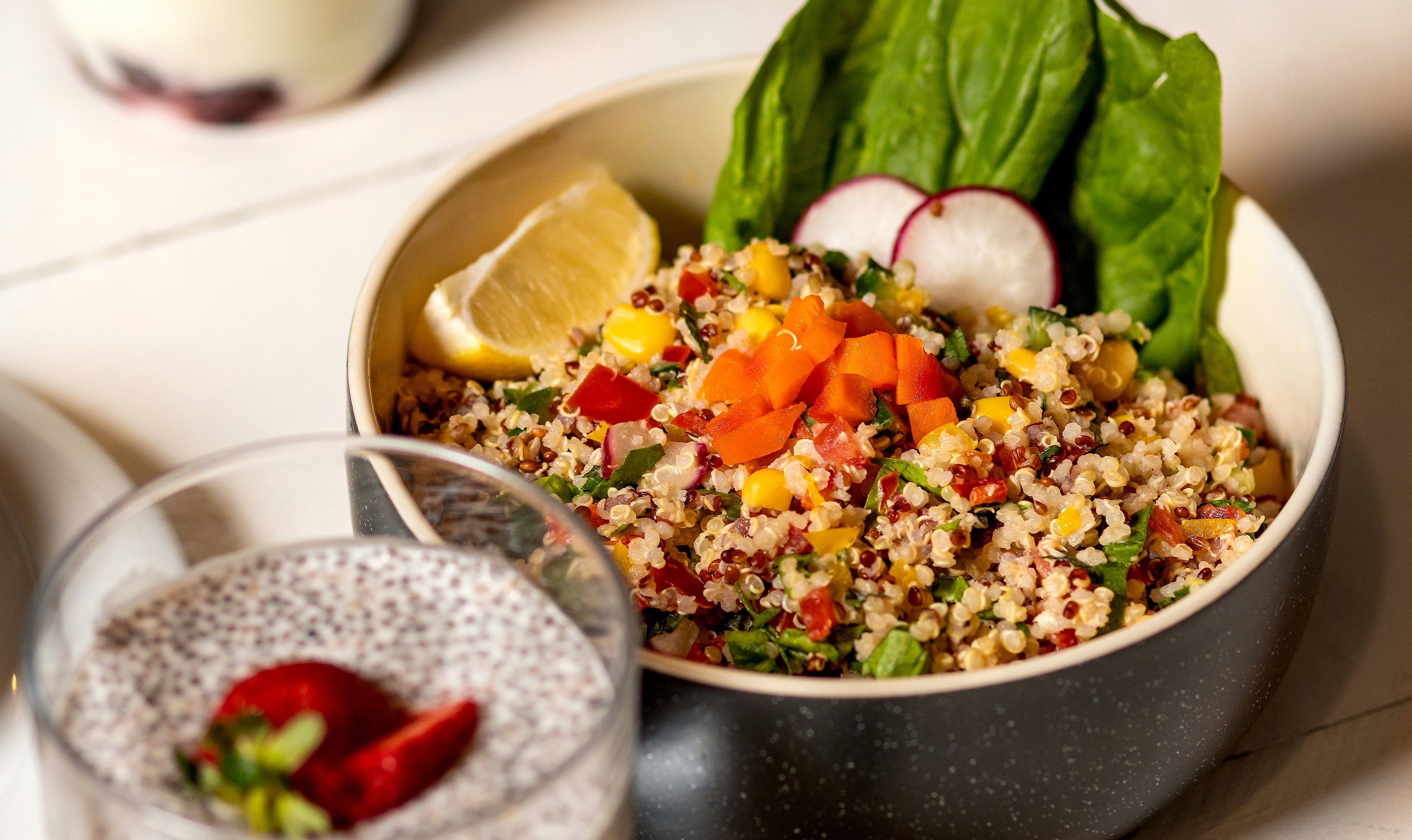 quinoa salad in a black ceramic bowl